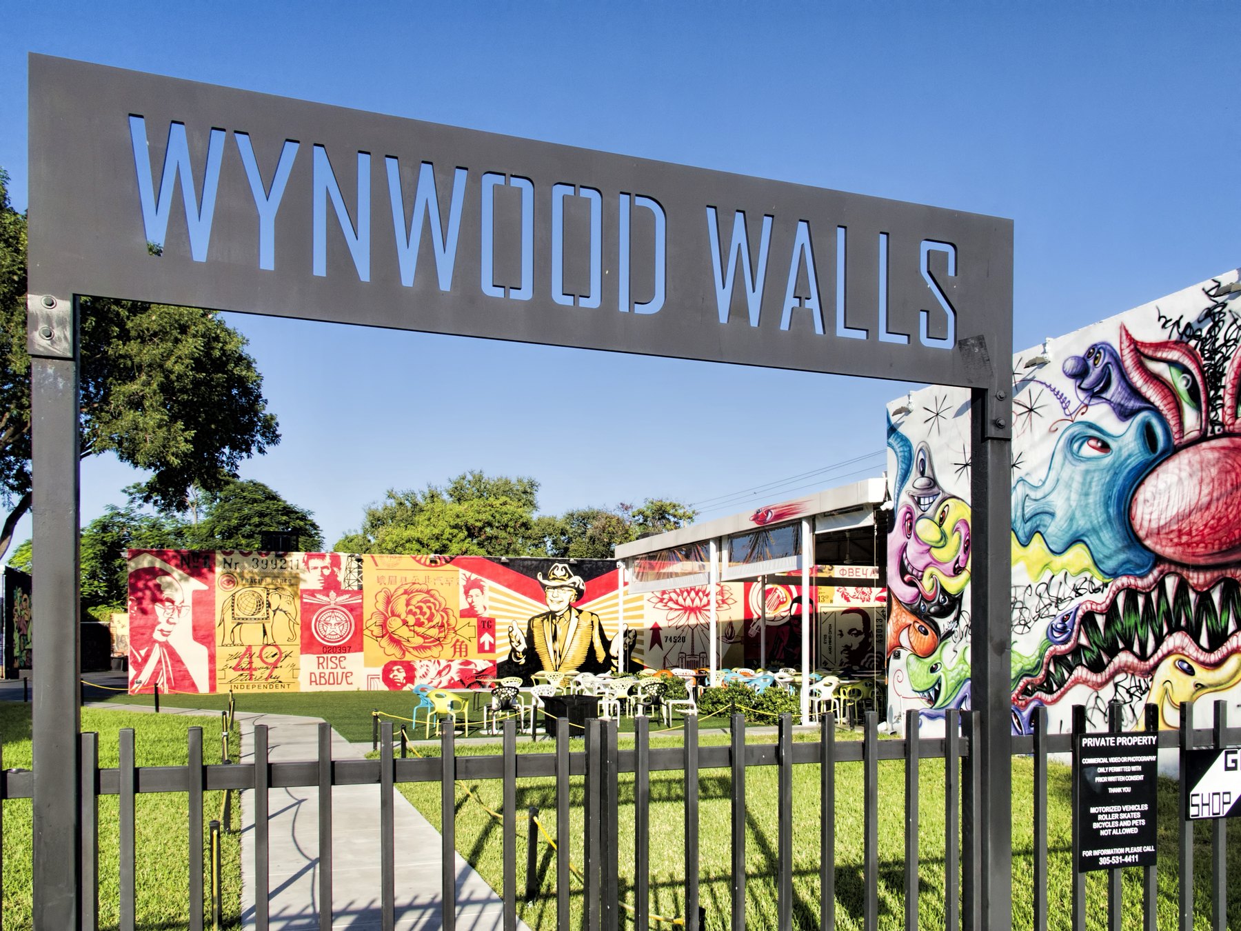 Colorful murals and visitors at Wynwood Walls in Miami.